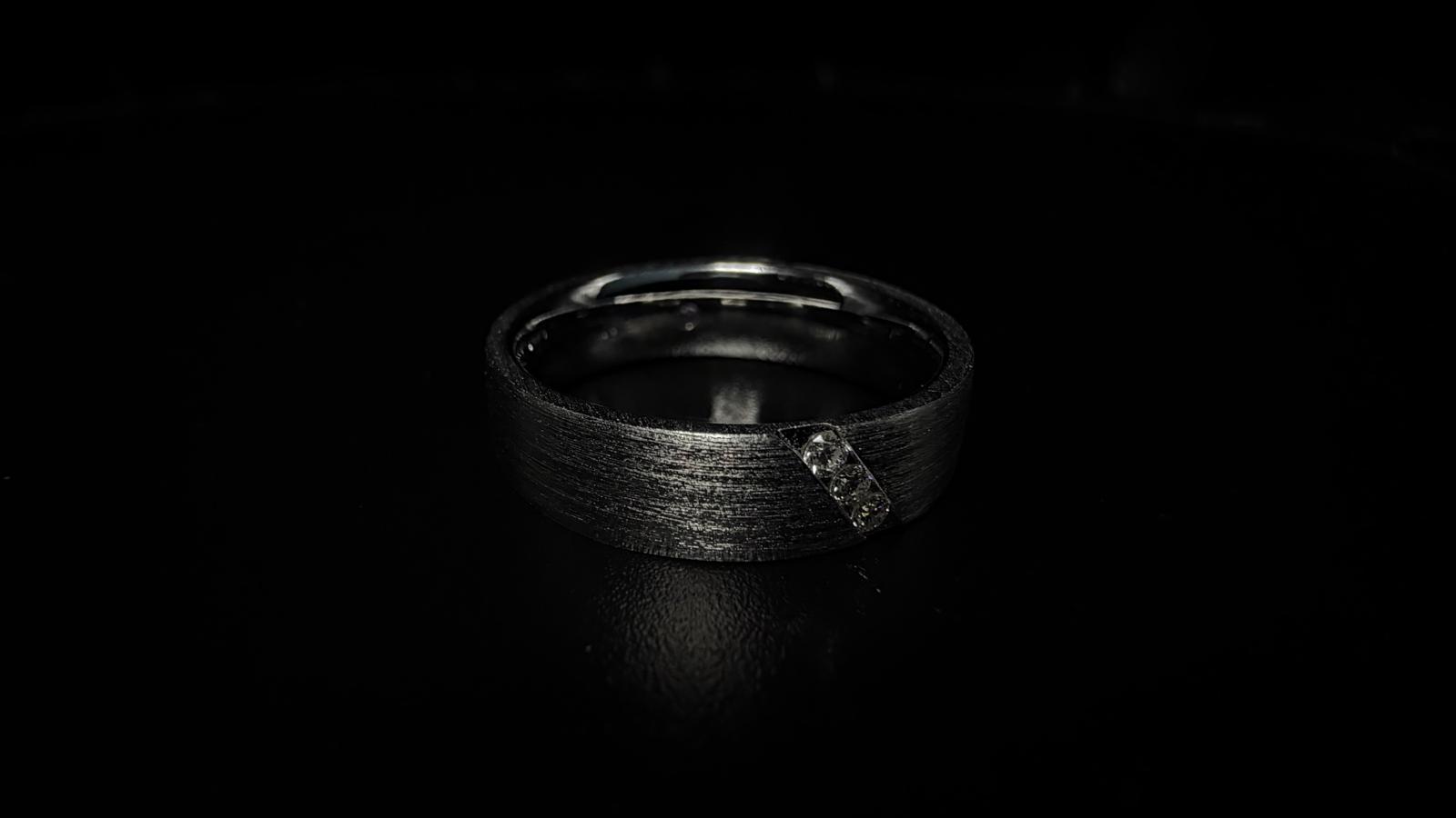 A textured finish and a distinctive stone-set detail.